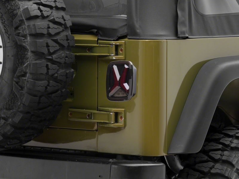 Load image into Gallery viewer, Raxiom 76-06 Jeep CJ7 Wrangler YJ & TJ Gladiator LED Tail Lights- Blk Housing (Smoked Lens)