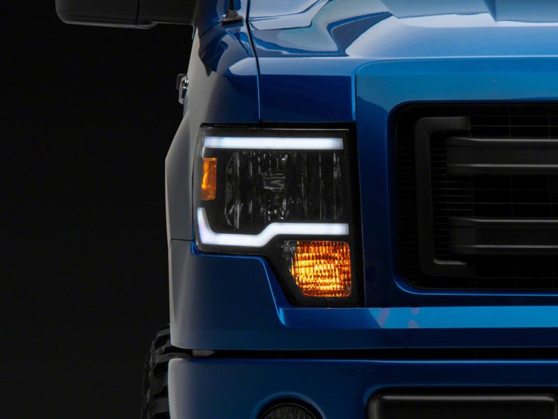 Load image into Gallery viewer, Raxiom 09-14 Ford F-150 Axial Series Headlight w/ SEQL LED Bar- Black Housing (Clear Lens)