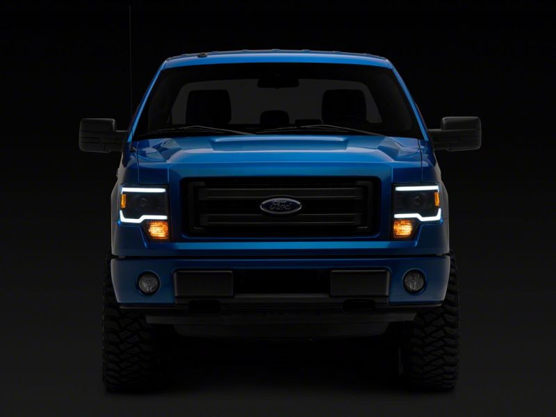 Load image into Gallery viewer, Raxiom 09-14 Ford F-150 Axial Series Projector Headlights w/ LED Light Bar- Blk Housing (Clear Lens)