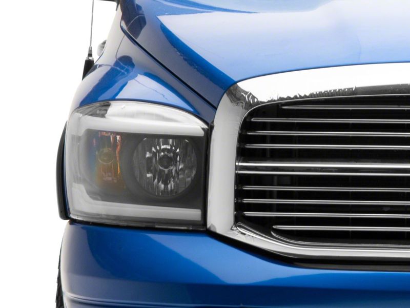 Load image into Gallery viewer, Raxiom 06-09 Dodge RAM 1500/2500/3500 Axial Headlights w/ SEQL LED Bar- Black Housing (Clear Lens)