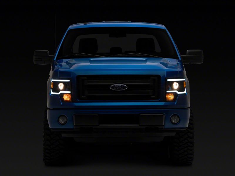 Load image into Gallery viewer, Raxiom 09-14 Ford F-150 Axial Series Projector Headlights w/ LED Light Bar- Blk Housing (Clear Lens)