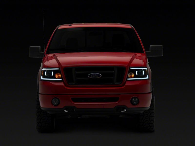 Load image into Gallery viewer, Raxiom 04-08 Ford F-150 Axial Series Projector Headlights w/ SEQL LED Bar- Blk Housing (Clear Lens)