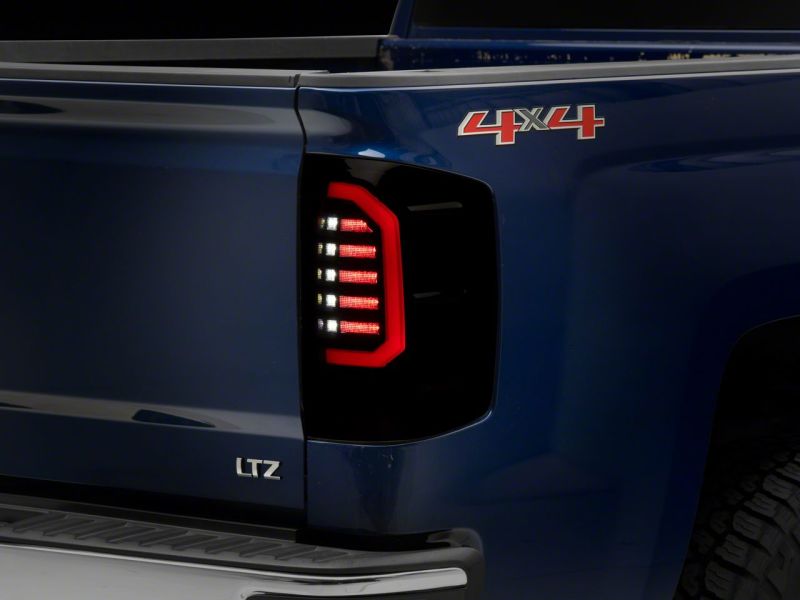 Load image into Gallery viewer, Raxiom 14-18 Chevrolet Silverado 1500 Axial Series LED Tail Lights- Blk Housing (Smoked Lens)