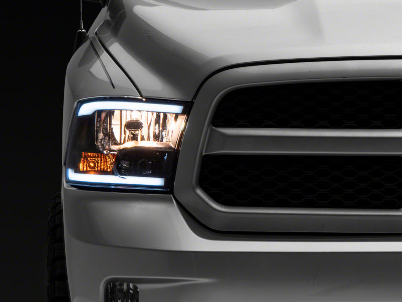 Load image into Gallery viewer, Raxiom 09-18 Dodge RAM 1500/2500/3500 Axial Series Headlights w/ LED Bar- Black Housing (Clear Lens)