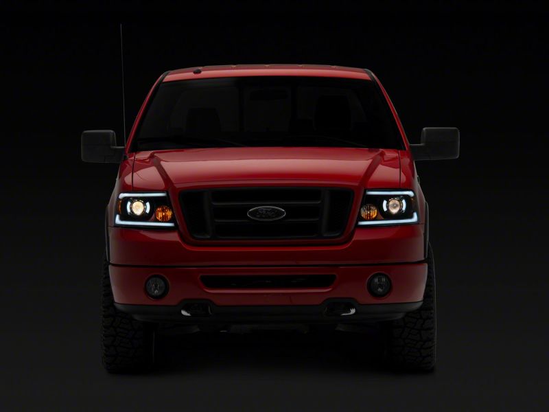 Load image into Gallery viewer, Raxiom 04-08 Ford F-150 Axial Series Projector Headlights w/ SEQL LED Bar- Blk Housing (Clear Lens)