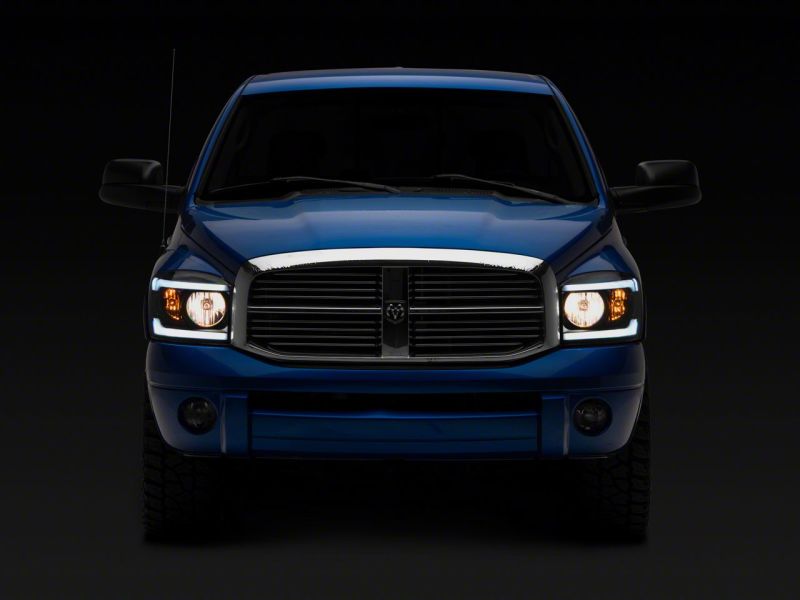 Load image into Gallery viewer, Raxiom 06-09 Dodge RAM 1500/2500/3500 Axial Headlights w/ SEQL LED Bar- Black Housing (Clear Lens)
