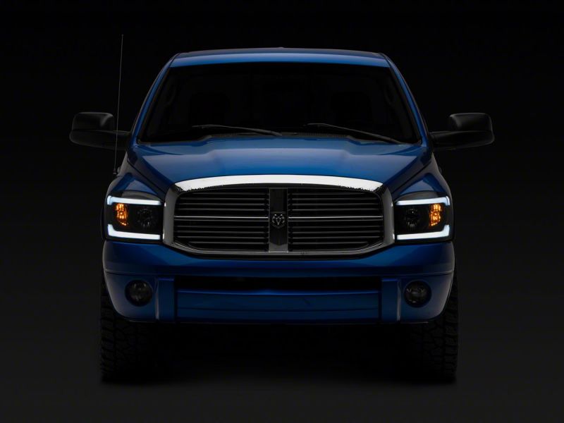 Load image into Gallery viewer, Raxiom 06-09 Dodge RAM 1500/2500/3500 Axial Headlights w/ SEQL LED Bar- Black Housing (Clear Lens)