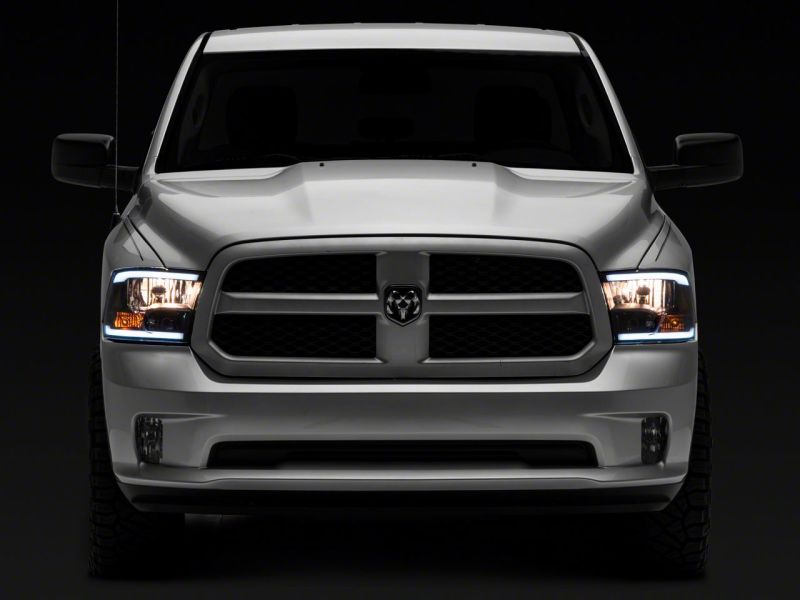 Load image into Gallery viewer, Raxiom 09-18 Dodge RAM 1500/2500/3500 Axial Series Headlights w/ LED Bar- Black Housing (Clear Lens)