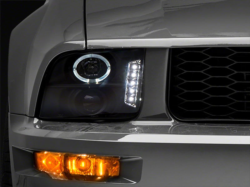 Load image into Gallery viewer, Raxiom 05-09 Ford Mustang Excluding GT500 LED Halo Projector Headlights- Black Housing (Clear Lens)