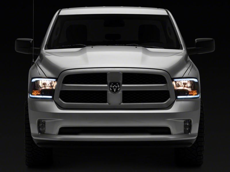 Load image into Gallery viewer, Raxiom 09-18 Dodge RAM 1500/2500/3500 Axial Headlights w/ SEQL LED Bar- Black Housing (Clear Lens)