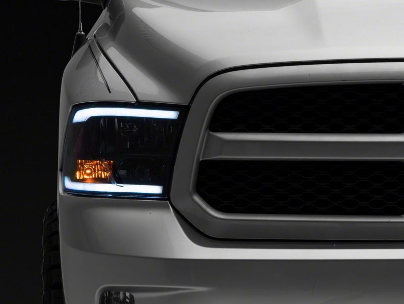 Load image into Gallery viewer, Raxiom 09-18 Dodge RAM 1500/2500/3500 Axial Headlights w/ SEQL LED Bar- Black Housing (Clear Lens)