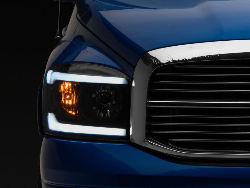 Load image into Gallery viewer, Raxiom 06-09 Dodge RAM 1500/2500/3500 Axial Headlights w/ SEQL LED Bar- Black Housing (Clear Lens)
