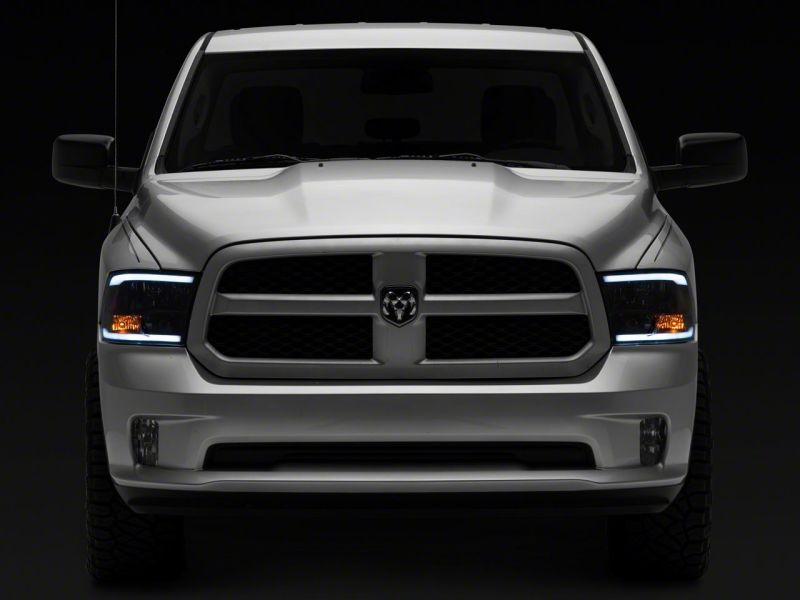 Load image into Gallery viewer, Raxiom 09-18 Dodge RAM 1500/2500/3500 Axial Headlights w/ SEQL LED Bar- Black Housing (Clear Lens)