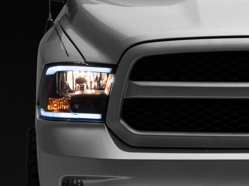 Load image into Gallery viewer, Raxiom 09-18 Dodge RAM 1500/2500/3500 Axial Headlights w/ SEQL LED Bar- Black Housing (Clear Lens)