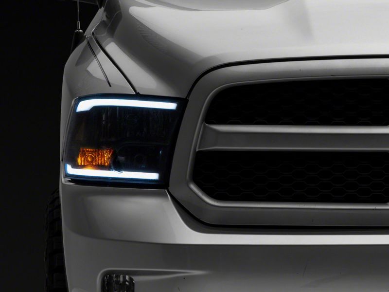 Load image into Gallery viewer, Raxiom 09-18 Dodge RAM 1500/2500/3500 Axial Series Headlights w/ LED Bar- Black Housing (Clear Lens)