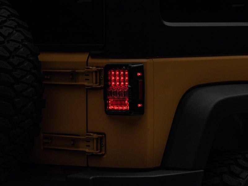 Load image into Gallery viewer, Raxiom 07-18 Jeep Wrangler JK Axial Series Lux LED Tail Lights- Blk Housing (Clear Lens)