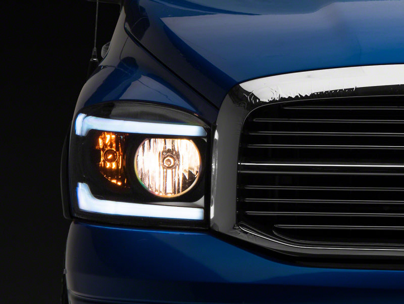 Load image into Gallery viewer, Raxiom 06-09 Dodge RAM 1500/2500/3500 Axial Headlights w/ SEQL LED Bar- Black Housing (Clear Lens)