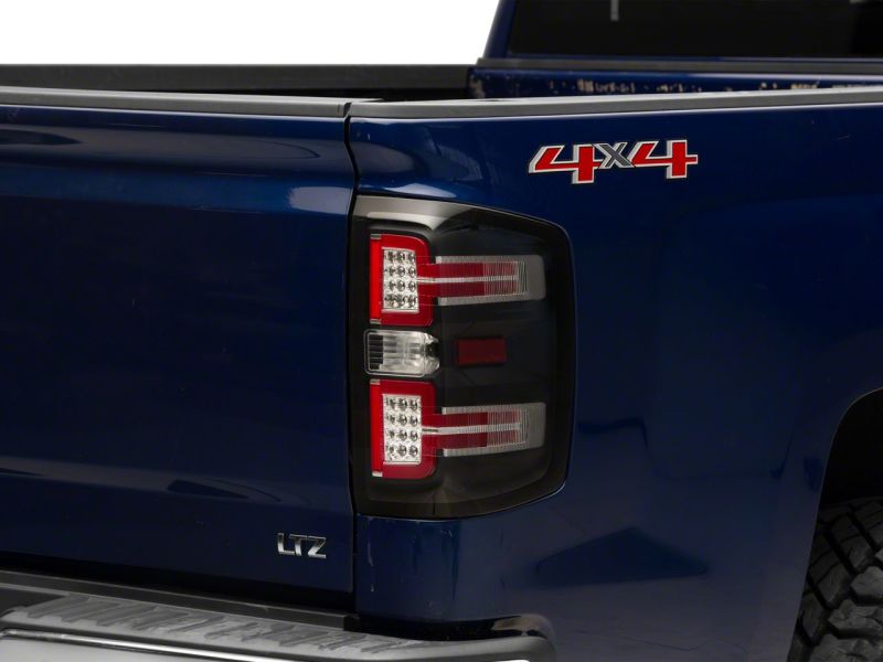 Load image into Gallery viewer, Raxiom 14-18 Chevrolet Silverado 1500 LED Taillights w/ SEQL Turn Signals- Blk Housing (Clear Lens)
