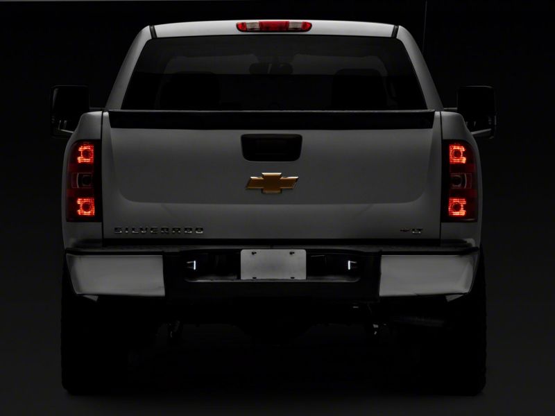 Load image into Gallery viewer, Raxiom 01-13 Chevrolet Silverado/GMC Sierra 1500 Axial Series LED License Plate Lamps- Smoked
