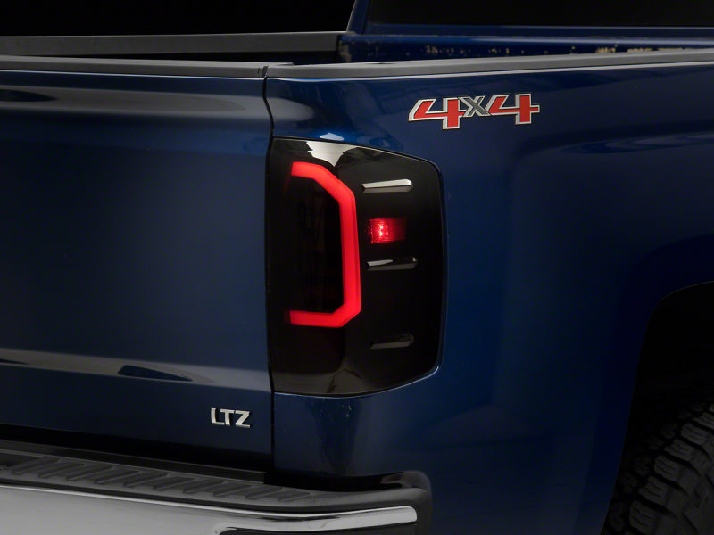 Load image into Gallery viewer, Raxiom 14-18 Chevrolet Silverado 1500 Axial Series LED Tail Lights- Blk Housing (Smoked Lens)
