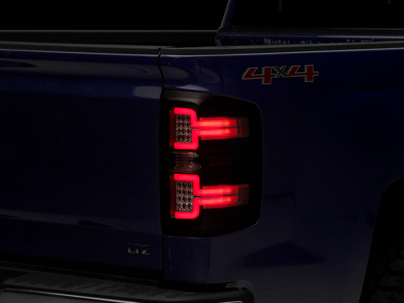 Load image into Gallery viewer, Raxiom 14-18 Chevrolet Silverado 1500 LED Taillights w/ SEQL Turn Signals- Blk Housing (Clear Lens)
