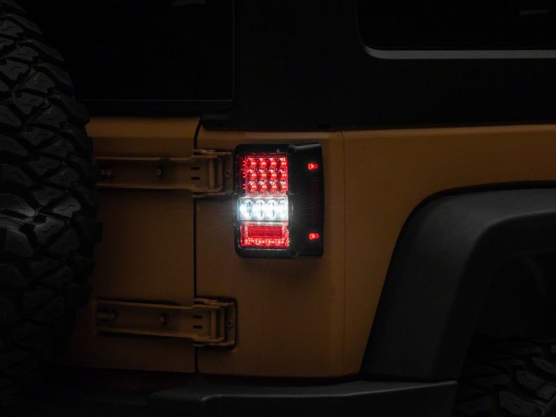 Load image into Gallery viewer, Raxiom 07-18 Jeep Wrangler JK Axial Series Lux LED Tail Lights- Blk Housing (Clear Lens)
