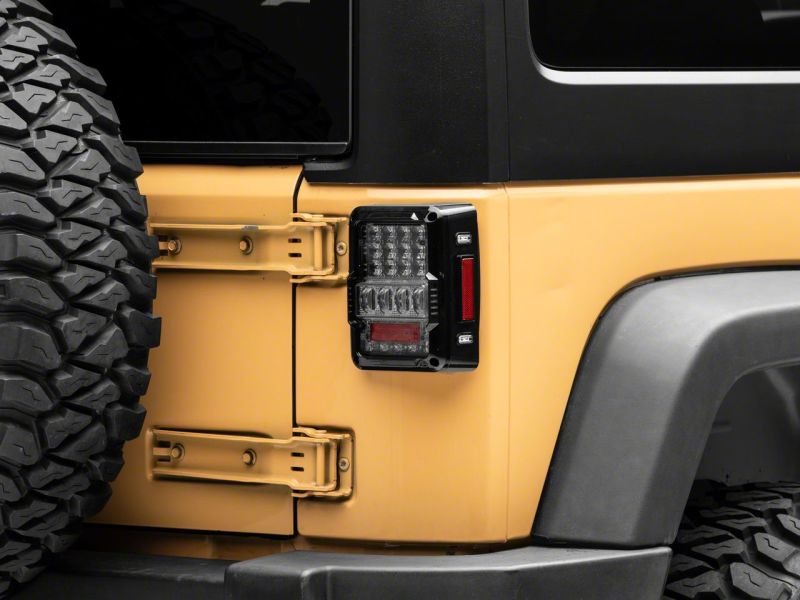 Load image into Gallery viewer, Raxiom 07-18 Jeep Wrangler JK Axial Series Lux LED Tail Lights- Blk Housing (Clear Lens)
