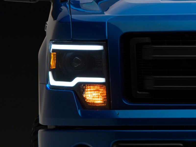 Load image into Gallery viewer, Raxiom 09-14 Ford F-150 Axial Series Projector Headlights w/ LED Light Bar- Blk Housing (Clear Lens)
