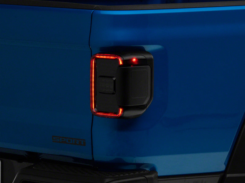 Load image into Gallery viewer, Raxiom 20-23 Jeep Gladiator JT w/ Factory Halogen LED Tail Lights- Blk Housing (Smoked Lens)
