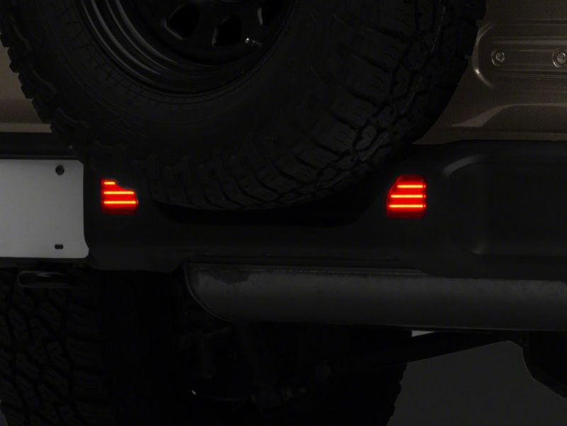 Load image into Gallery viewer, Raxiom 18-23 Jeep Wrangler JL Moab Rubicon Sahara Axial LED Rear Bumper Reflector Lights- Smoked
