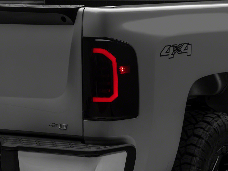 Load image into Gallery viewer, Raxiom 07-14 Chevrolet Silverado 1500 Axial Series LED Tail Lights- Blk Housing (Smoked Lens)
