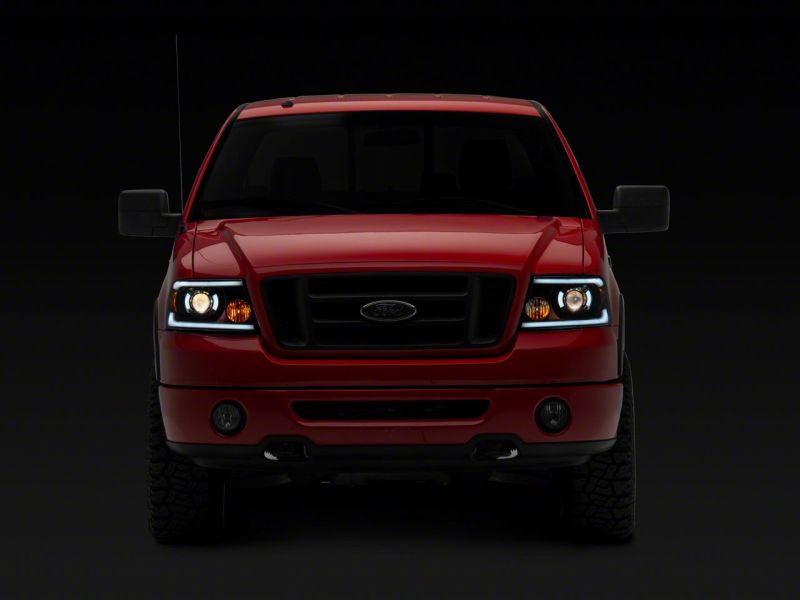 Load image into Gallery viewer, Raxiom 04-08 Ford F-150 Axial Series Projector Headlights w/ SEQL LED Bar- Blk Housing (Clear Lens)
