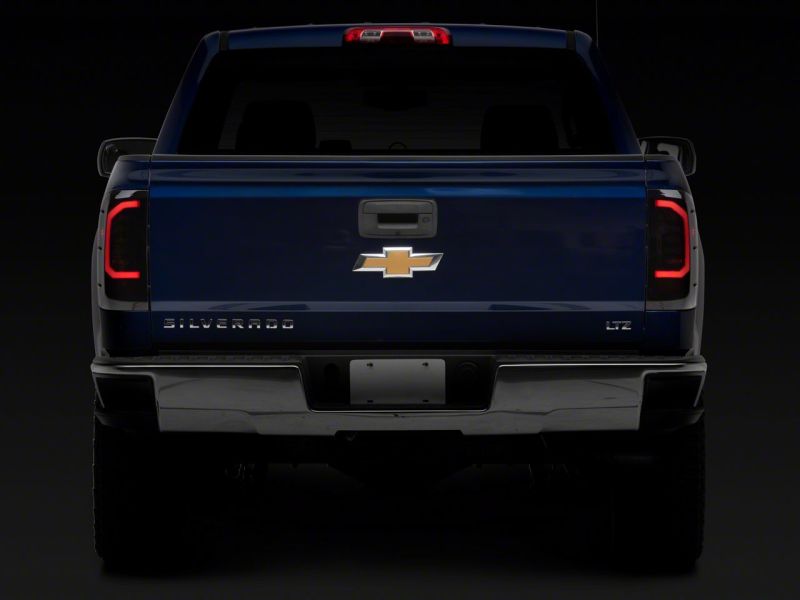 Load image into Gallery viewer, Raxiom 14-18 Chevrolet Silverado 1500 Axial Series LED Tail Lights- Blk Housing (Smoked Lens)
