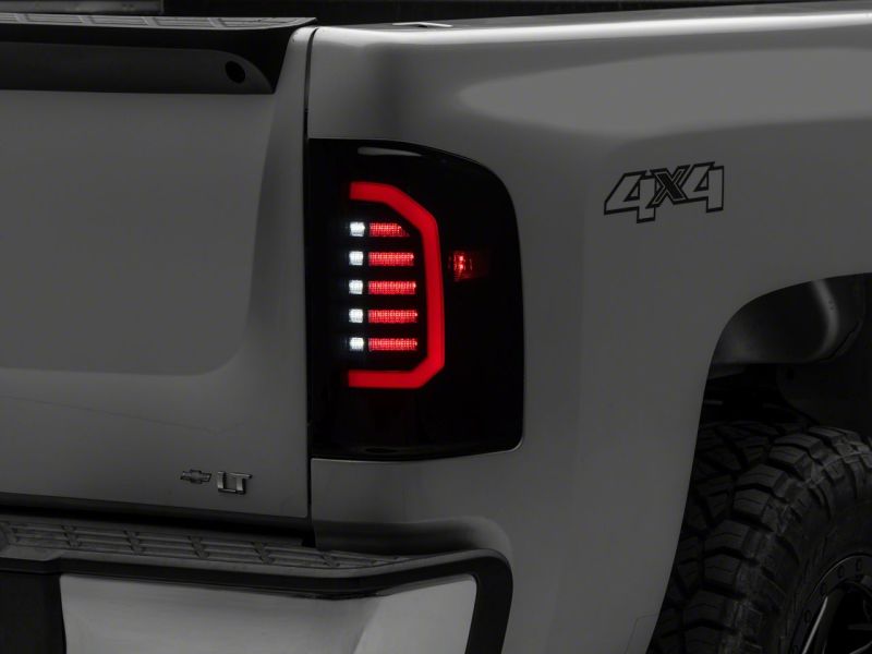 Load image into Gallery viewer, Raxiom 07-14 Chevrolet Silverado 1500 Axial Series LED Tail Lights- Blk Housing (Smoked Lens)
