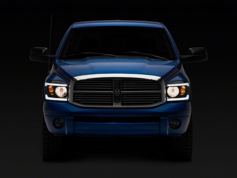 Load image into Gallery viewer, Raxiom 06-09 Dodge RAM 1500/2500/3500 Axial Headlights w/ SEQL LED Bar- Blk Housing (Clear Lens)
