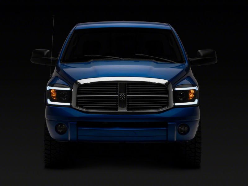 Load image into Gallery viewer, Raxiom 06-09 Dodge RAM 1500/2500/3500 Axial Headlights w/ SEQL LED Bar- Blk Housing (Clear Lens)
