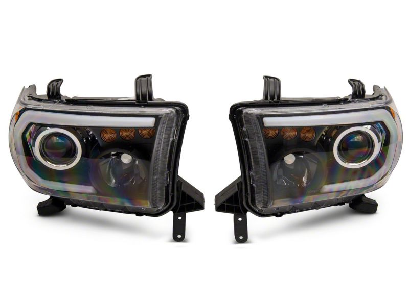 Load image into Gallery viewer, Raxiom 07-13 Toyota Tundra Axial Series Projector Headlights w/ LED Bar- Blk Housing (Clear Lens)
