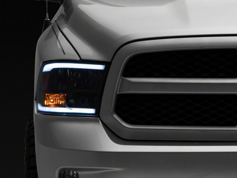 Load image into Gallery viewer, Raxiom 09-18 Dodge RAM 1500/2500/3500 Axial Headlights w/ SEQL LED Bar- Blk Housing (Clear Lens)
