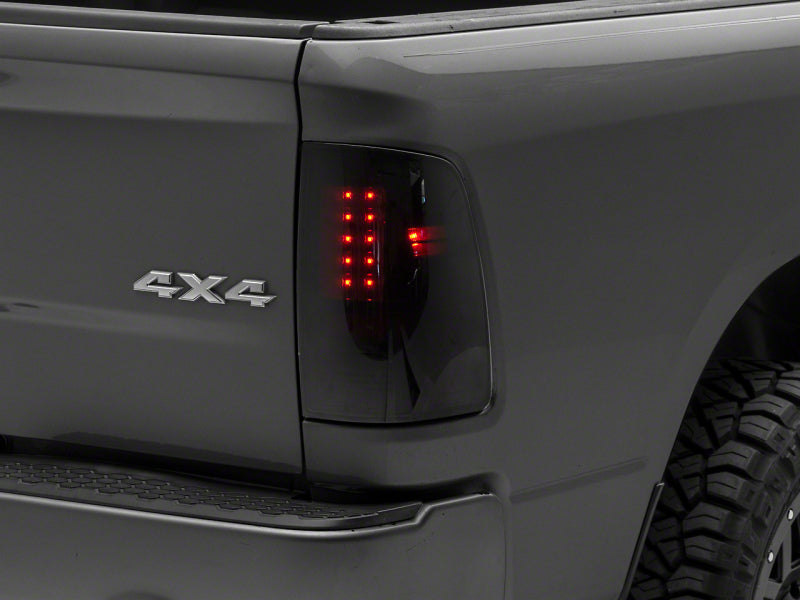 Load image into Gallery viewer, Raxiom 09-18 Dodge RAM 1500/2500/3500 Axial Series LED Tail Lights- BlkHousing- SmokedLens
