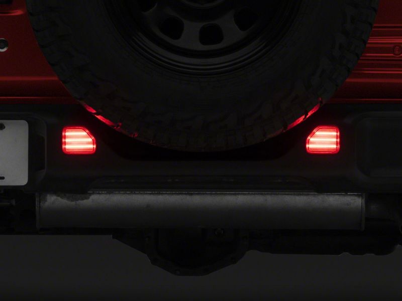 Load image into Gallery viewer, Raxiom 18-23 Jeep Wrangler JL Moab Rubicon Sahara Axial LED Rear Bumper Reflector Lights- Clear
