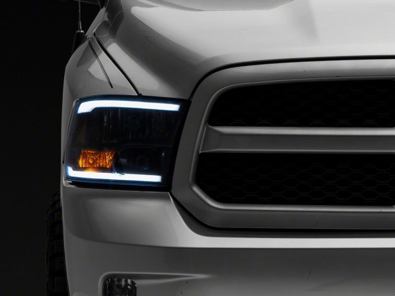 Load image into Gallery viewer, Raxiom 09-18 Dodge RAM 1500/2500/3500 Axial Series Headlights w/ LED Bar- Blk Housing (Clear Lens)
