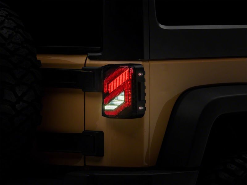 Load image into Gallery viewer, Raxiom 07-18 Jeep Wrangler JK Axial Series Trident LED Tail Lights- Blk Housing (Smoked Lens)
