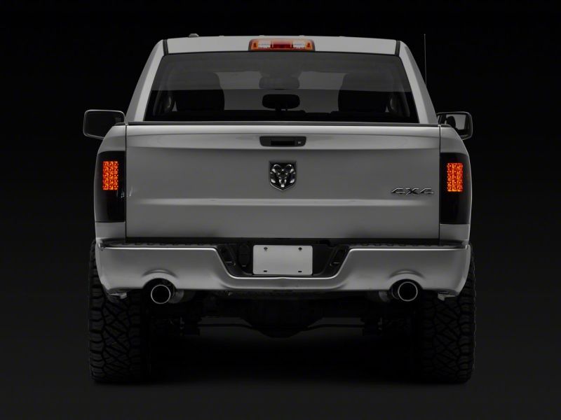 Load image into Gallery viewer, Raxiom 09-18 Dodge RAM 1500/2500/3500 Axial Series LED Tail Lights- BlkHousing- SmokedLens
