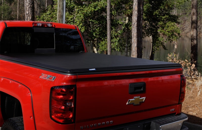 Load image into Gallery viewer, Lund 15-18 Ford F-150 Styleside (5.5ft. Bed) Hard Fold Tonneau Cover - Black
