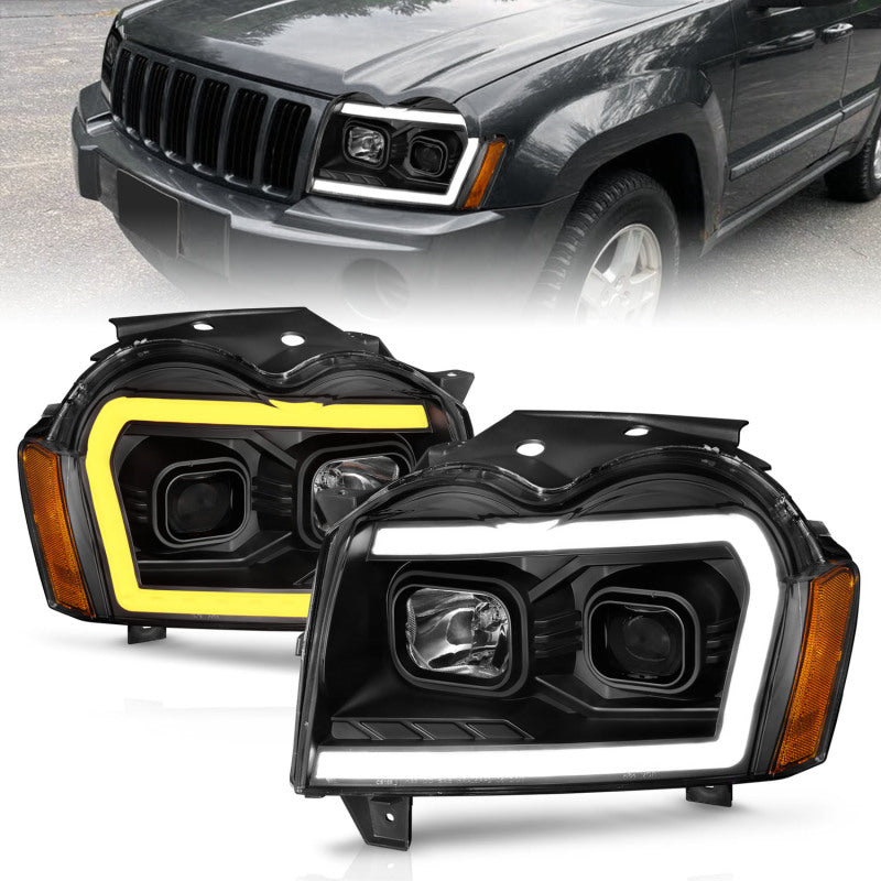 Load image into Gallery viewer, ANZO 2005-2007 Jeep Grand Cherokee Projector Headlights w/ Light Bar Switchback Black Housing
