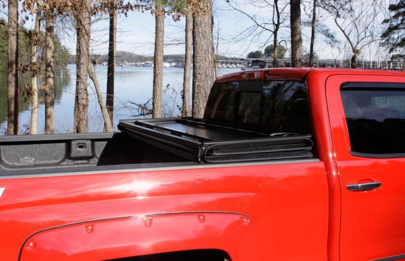 Load image into Gallery viewer, Lund 88-99 Chevy C1500 Fleetside (8ft. Bed) Hard Fold Tonneau Cover - Black
