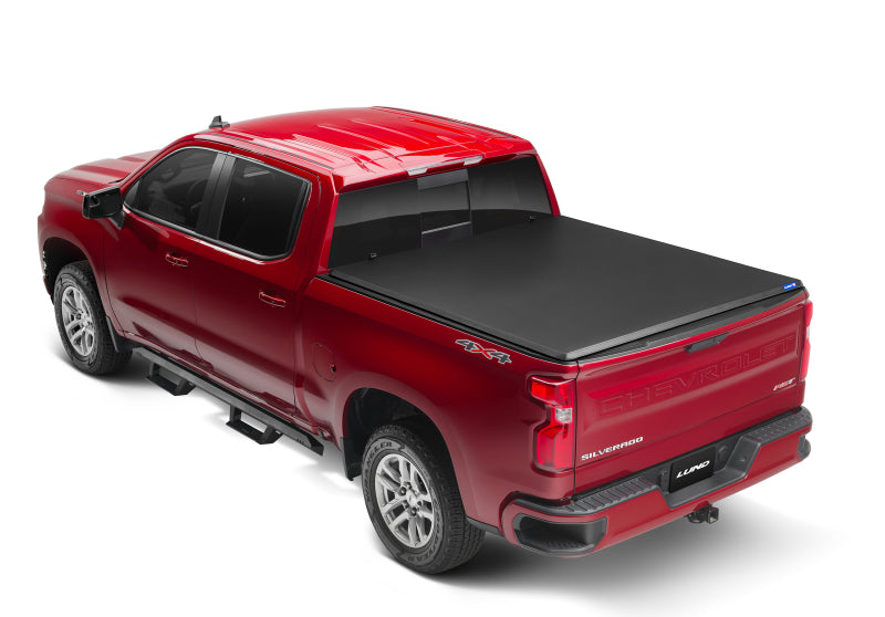 Load image into Gallery viewer, Lund 04-15 Nissan Titan (5.5ft. Bed) Hard Fold Tonneau Cover w/Bracket Kit - Black
