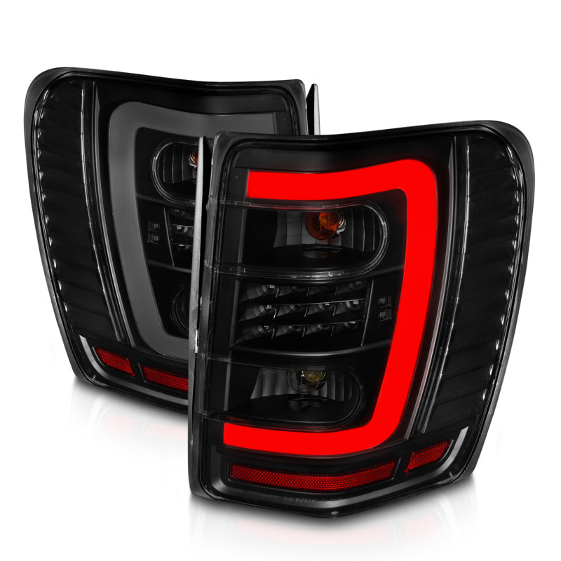 Load image into Gallery viewer, ANZO 1999-2004 Jeep Grand Cherokee LED Tail Lights w/ Light Bar Black Housing Smoke Lens
