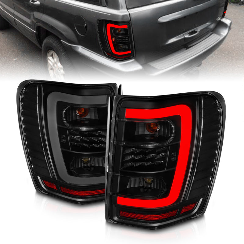 Load image into Gallery viewer, ANZO 1999-2004 Jeep Grand Cherokee LED Tail Lights w/ Light Bar Black Housing Smoke Lens
