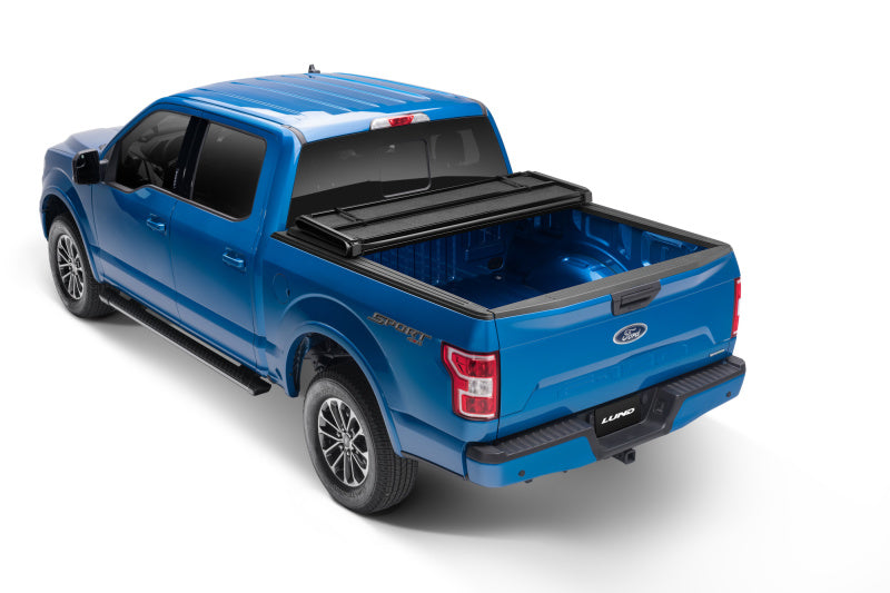 Load image into Gallery viewer, Lund 99-17 Ford F-250 Super Duty Styleside (6.8ft. Bed) Hard Fold Tonneau Cover - Black

